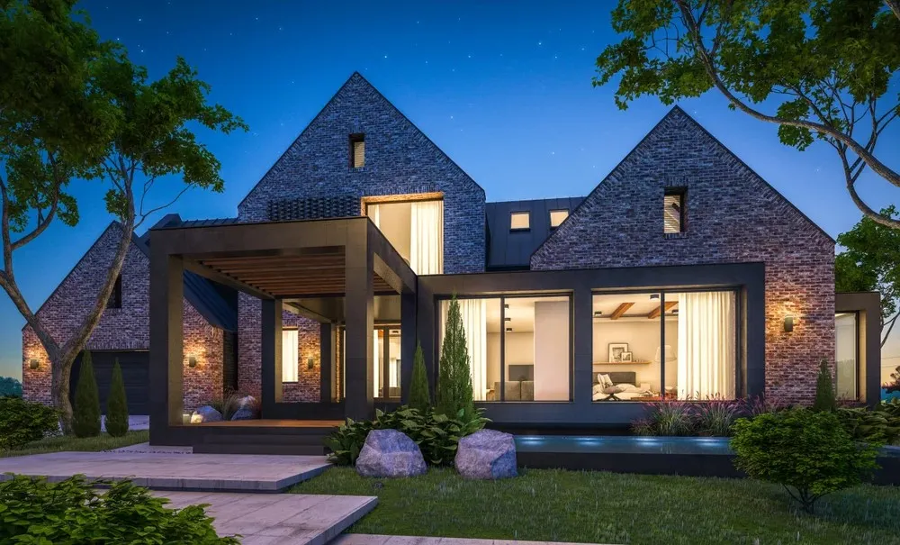 Modern two-story brick house with large windows, a sloped roof, and a covered entrance, surrounded by trees and landscaping.